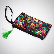 This image is of the Butterfly Flower Embroidered Clutch. Features: The material is for interior and exterior is cotton, the style is a day clutch, the closure is a zipper, the size is approximately 15cm x 27cm, no straps, interior compartment, embroidered pattern, green tassel on the end of the zipper.